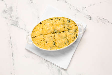 Baking dish with tasty rice casserole on white backgroundの写真素材