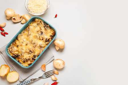 Baking dish with tasty rice casserole on light backgroundの写真素材