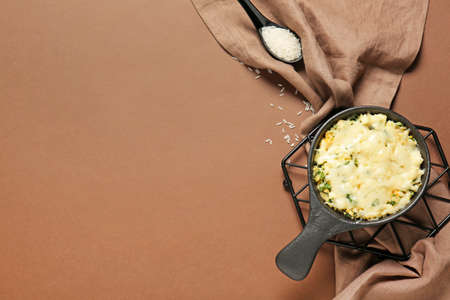 Baking dish with tasty rice casserole on color backgroundの写真素材