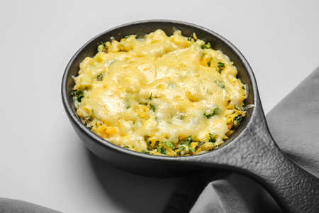 Baking dish with tasty rice casserole on light backgroundの写真素材