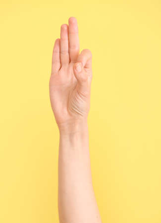 Hand showing letter F on color background. Sign language alphabetの写真素材