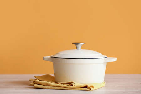 Cooking pot on table against color backgroundの写真素材