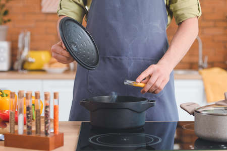 Man cooking dinner in kitchen