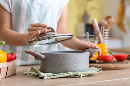 Woman cooking dinner in kitchen
