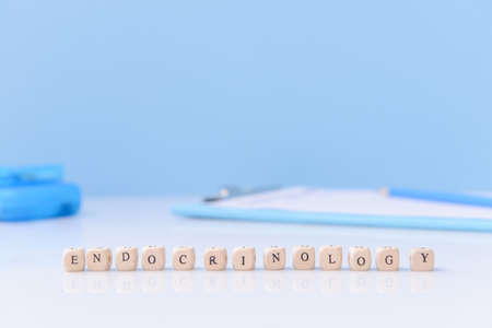 Word ENDOCRINOLOGY on table against color backgroundの写真素材