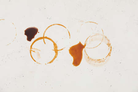 Coffee cup rings on light background, closeup