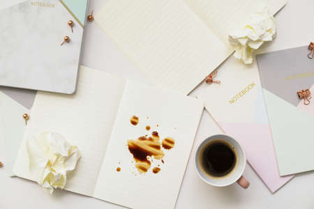 Cup and spilled coffee on table