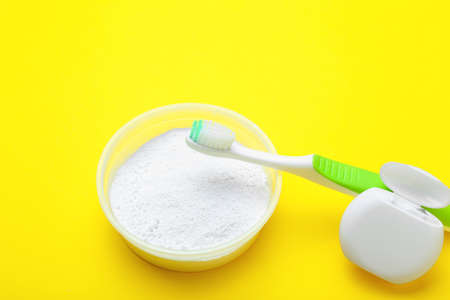 Tooth brush, powder and floss on color backgroundの写真素材