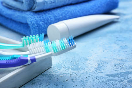 Tooth brushes and paste on color background