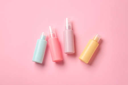 Set of travel bottles with body care cosmetics on color backgroundの写真素材