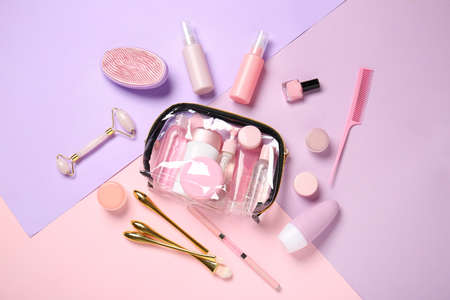 Travel cosmetics kit and transparent bag on color backgroundの写真素材