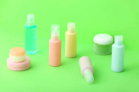 Set of travel bottles with cosmetic products on color backgroundの写真素材