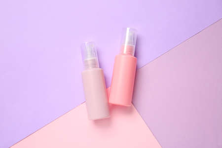 Set of travel bottles with body care cosmetics on color backgroundの写真素材