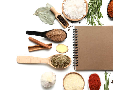 Empty notebook among various spices on white backgroundの写真素材