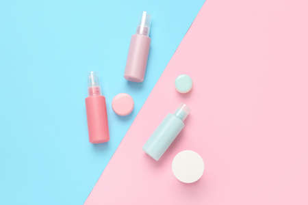 Set of travel bottles with cosmetic products on color backgroundの写真素材