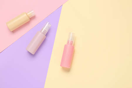 Set of travel bottles with body care cosmetics on color backgroundの写真素材
