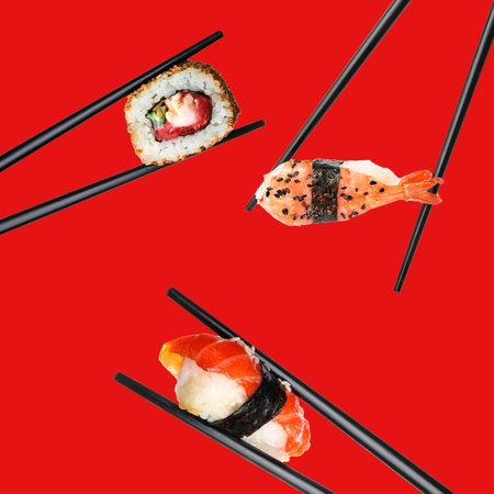 Chopsticks with tasty sushi on color backgroundの写真素材