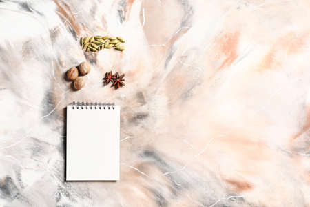 Notebook with spices on light backgroundの写真素材