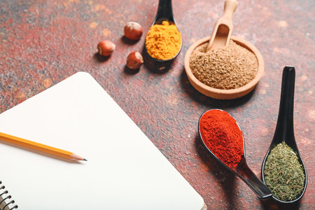 Notebook with different spices on grunge background closeupの写真素材