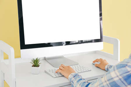 Woman using computer at table in room