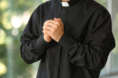 Male priest praying at homeの写真素材
