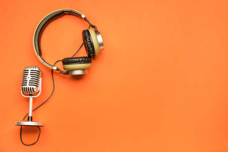 Headphones with microphone on color backgroundの写真素材