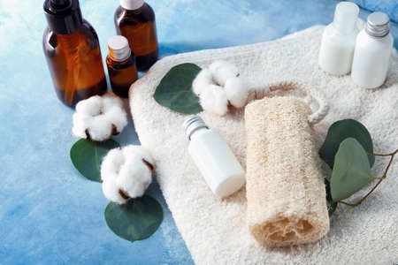 Composition with bath accessories, cosmetics and cotton flowers on color backgroundの写真素材