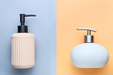 Dispenser bottles with liquid soap on color backgroundの写真素材