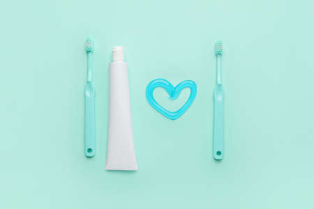 Toothbrushes and paste on color backgroundの写真素材
