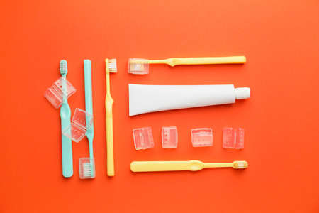 Toothbrushes and paste on color backgroundの写真素材