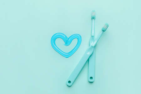 Toothbrushes and paste on color backgroundの写真素材
