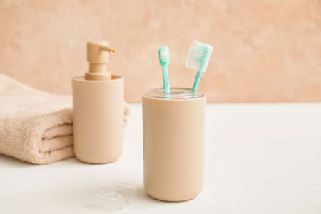 Toothbrushes with soap on table in bathroomの写真素材
