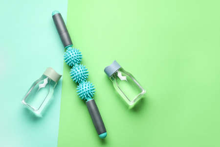 Bottles of water and body roller on color backgroundの写真素材