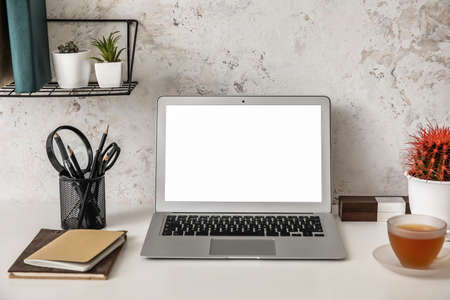 Comfortable workplace with modern laptop in room