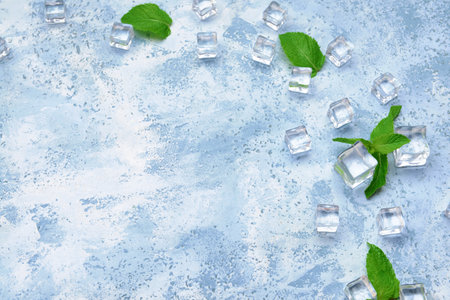 Ice cubes and mint on color backgroundの写真素材