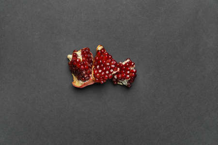 Pieces of fresh pomegranate on dark background