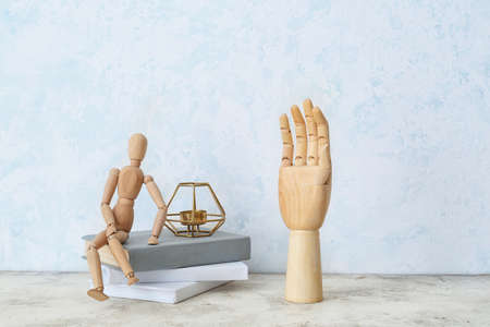 Wooden hand and mannequin on tableの写真素材