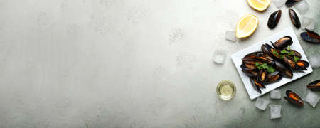 Plate with tasty mussels on grunge background with space for textの写真素材