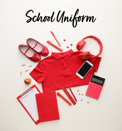 Stylish school uniform with stationery and modern gadgets on white backgroundの写真素材