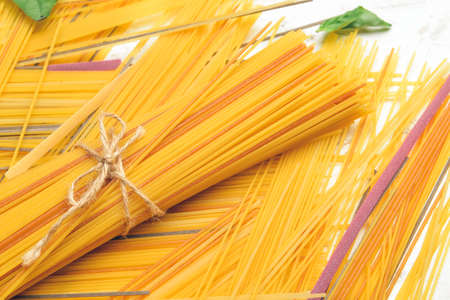 Uncooked spaghetti on light backgroundの写真素材