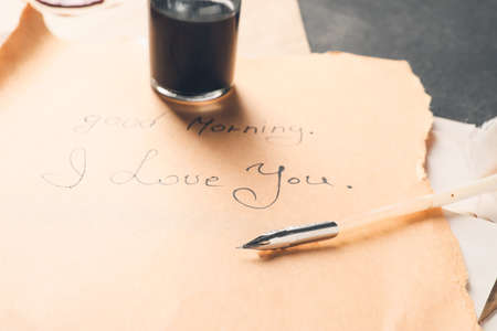 Vintage letter with feather pen on tableの写真素材