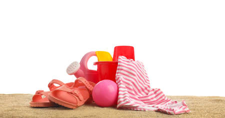 Set of beach accessories for children on sand against white backgroundの写真素材