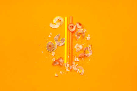Ordinary pencils and shavings on color background