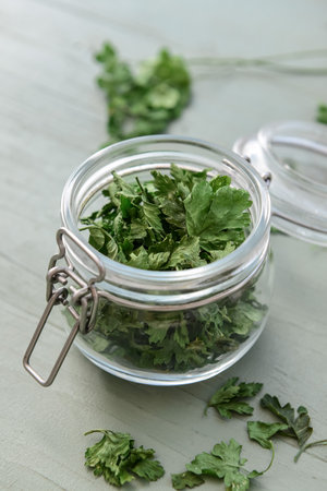 Jar with fresh parsley on tableの写真素材