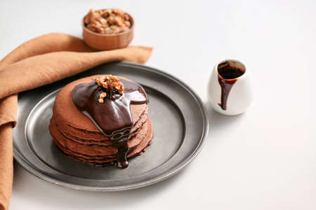 Plate with delicious chocolate pancakes on white backgroundの写真素材