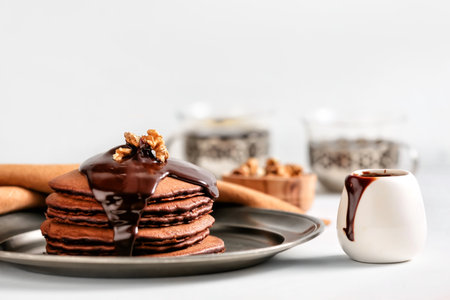 Plate with delicious chocolate pancakes on tableの写真素材