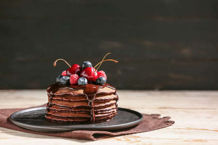 Plate with delicious chocolate pancakes on tableの写真素材