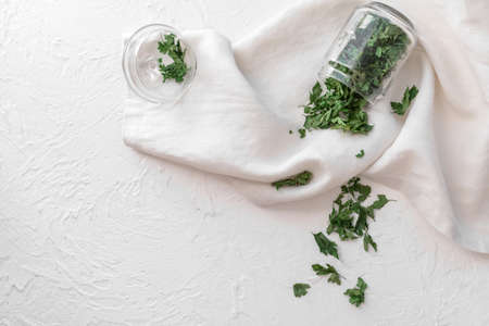 Jar with dry parsley on white backgroundの写真素材