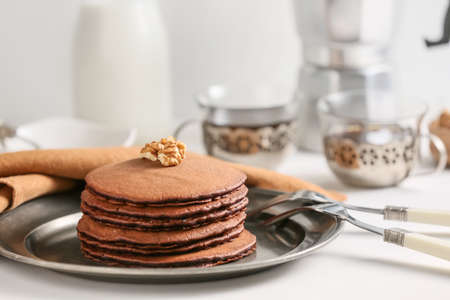 Plate with delicious chocolate pancakes on tableの写真素材