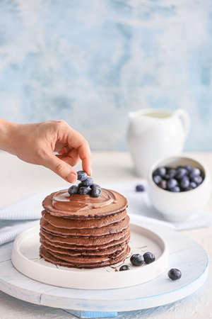 Decorating of delicious chocolate pancakesの写真素材